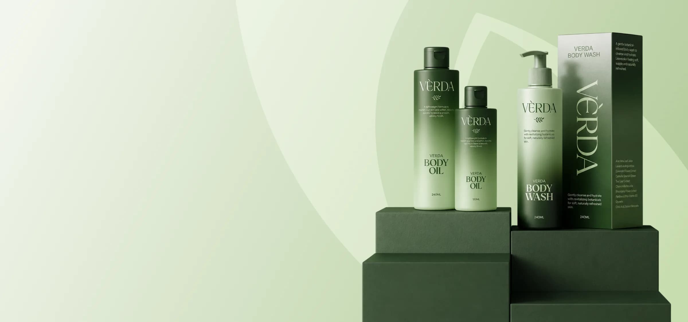Verda Body Oil and Body Wash bottles staged on green pedestals