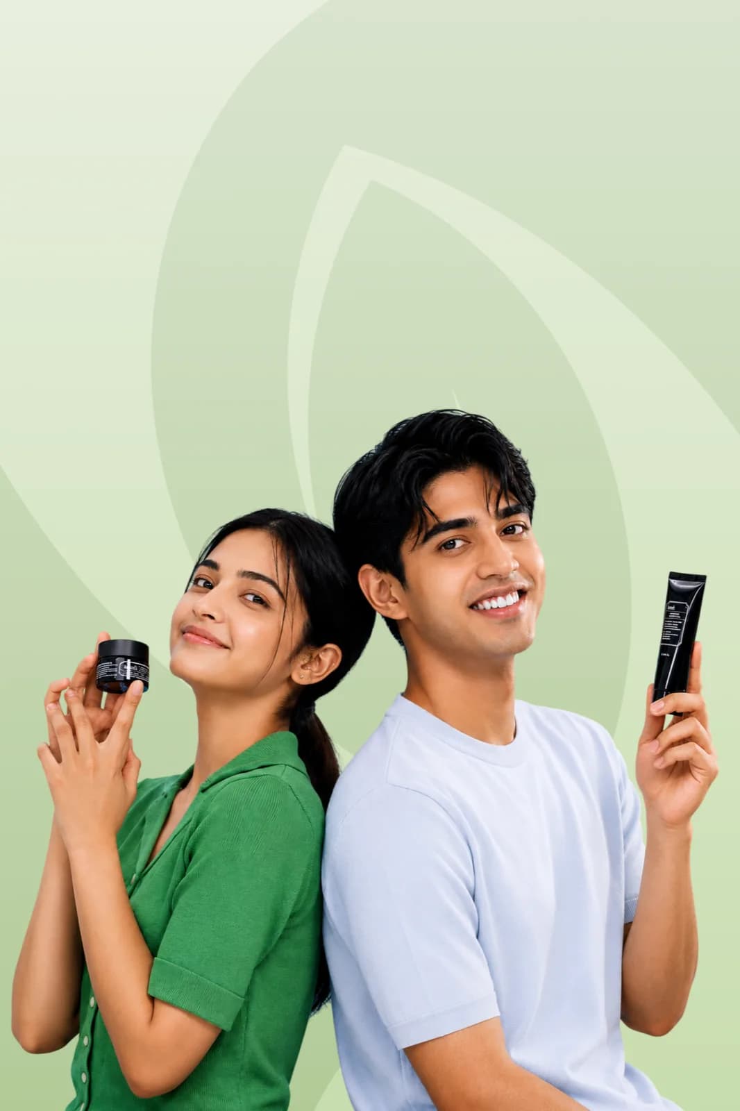 Two people holding Verda skincare products against a green backdrop